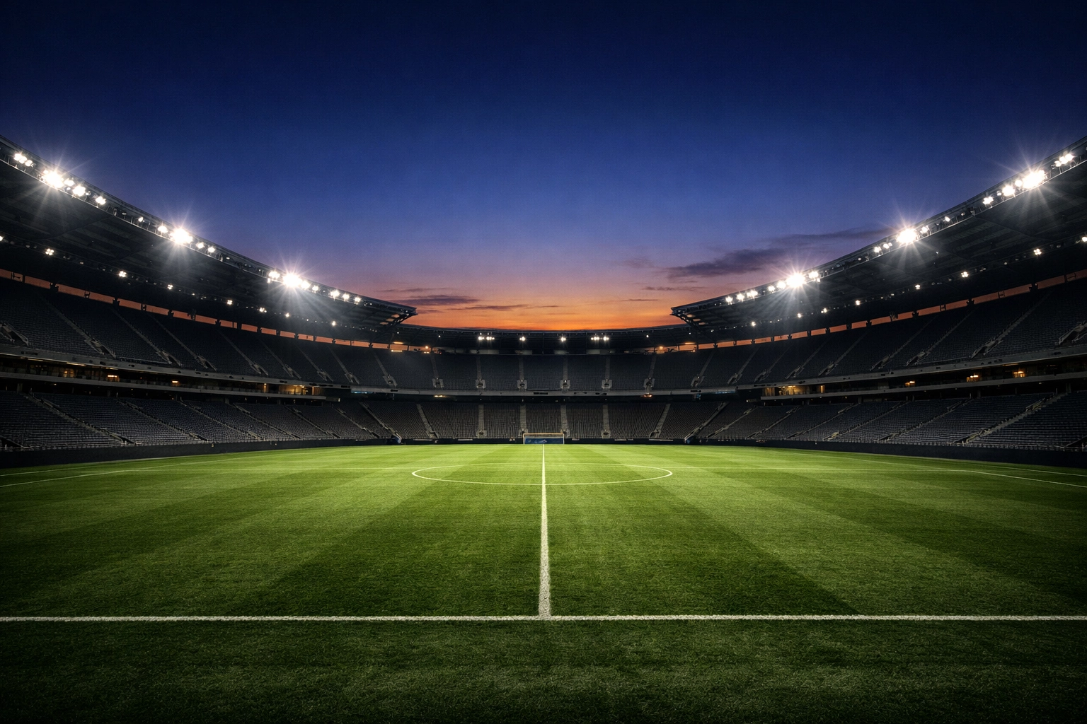 Ein modernes Fußballstadion unter Flutlicht vor den Abendspielen der Bundesliga.