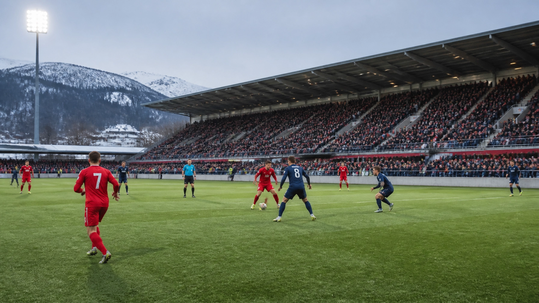 Fußballszene mit generischen roten und dunkelblauen Trikots im norwegischen Stadion