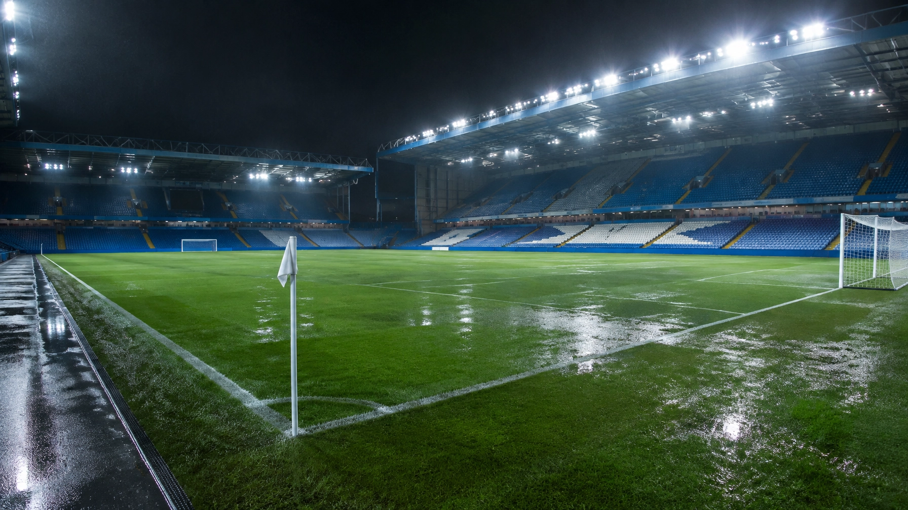 Flutlicht und nasser Rasen an einem neutral dargestellten englischen Fußballstadion